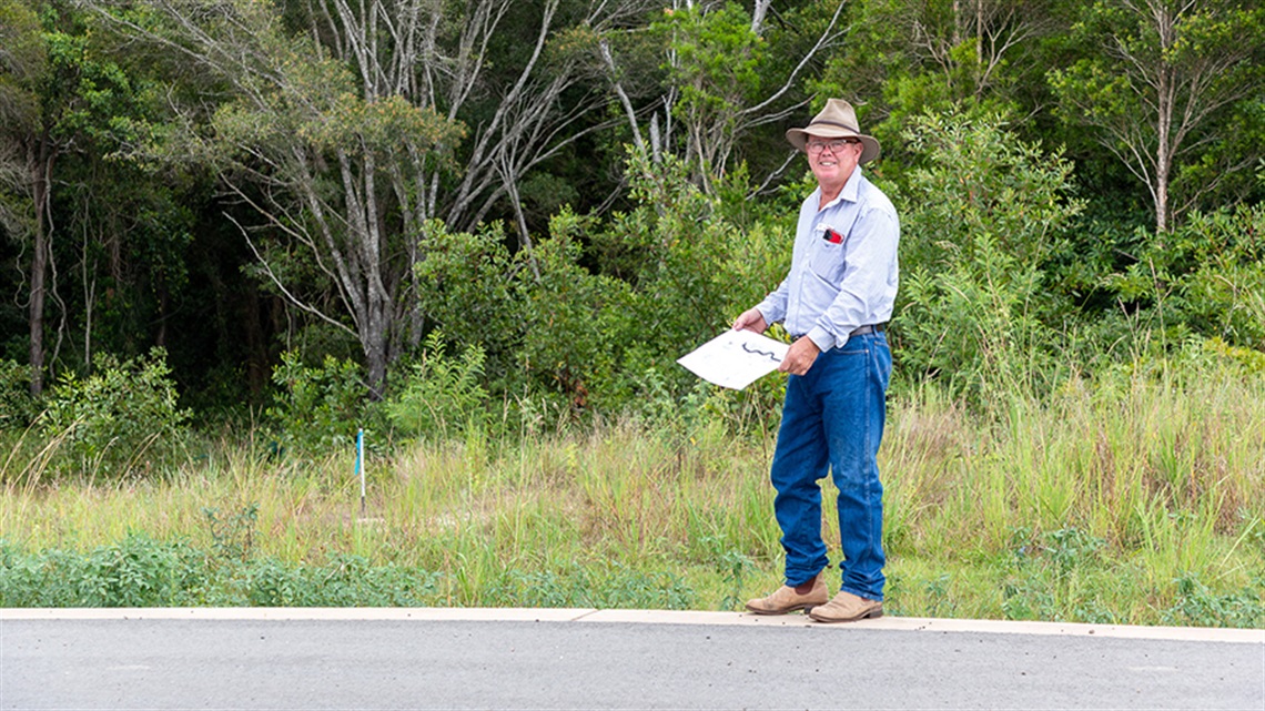 Cr Denis Chapman inspects the site of the proposed new footpath at The Springs